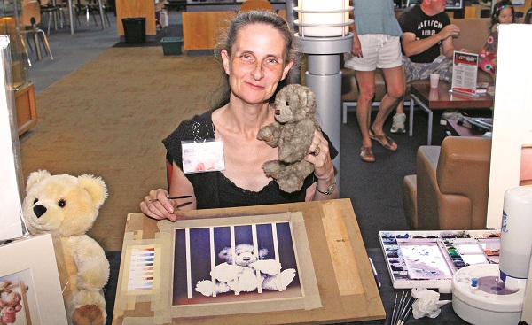 Artist Ona Kingdon was on hand at the Aurora Public Library, painting "IncarceraTED" -- the latest in her teddy bear-based TED series.