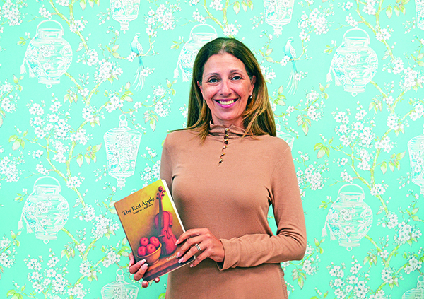 Aurora business owner is first-time novelist with The Red Apple